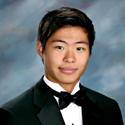 Young man in a tuxedo with a black bow tie poses for a formal portrait, representing St. Paul's School, a top school for boys Northshore LA.