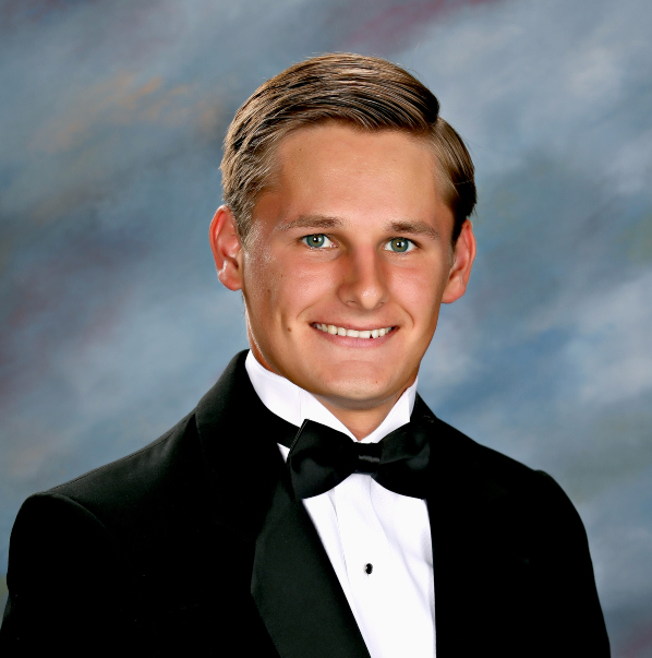 A young man in a black tuxedo and bow tie, representing St. Paul's School, poses for a formal portrait against a neutral studio background.