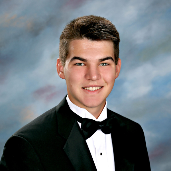 A young man in a tuxedo poses for a formal portrait, representing St. Paul’s School, a leading school for boys on the Northshore, LA.