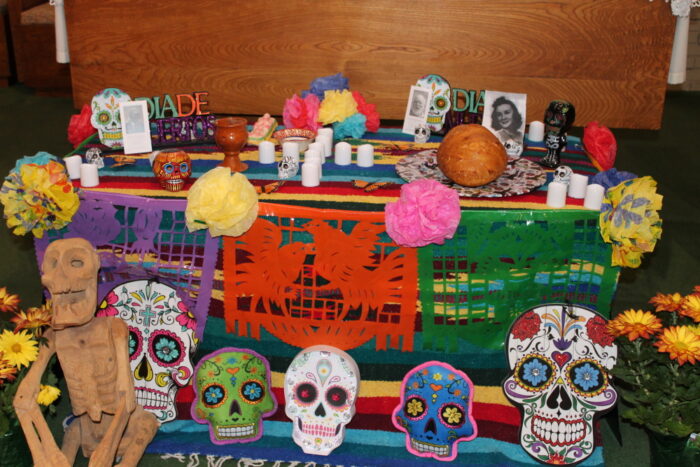 A colorful Day of the Dead altar brightens St. Paul's School, a leading school for boys on the Northshore, with flowers, candles, and papel picado.