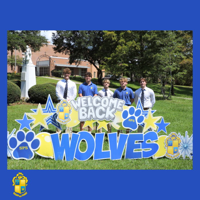 Five students from St. Paul's School in dress shirts and ties stand behind a 