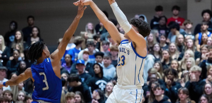 Two Basketball Wolves in action: a Mandeville High player shoots as Seicshnaydre leaps to block, with the crowd watching intently.